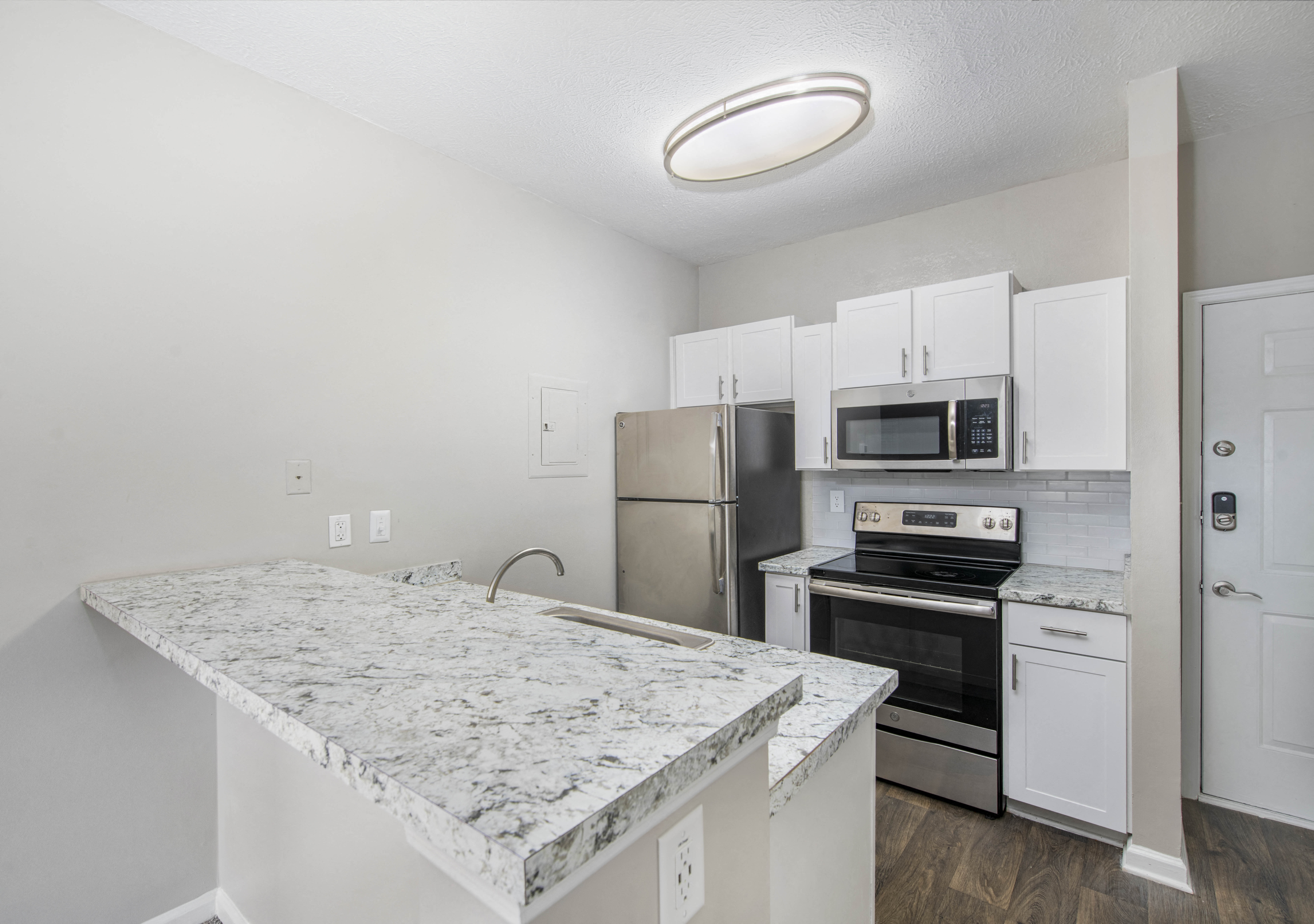 a kitchen with granite counter tops and stainless steel appliances